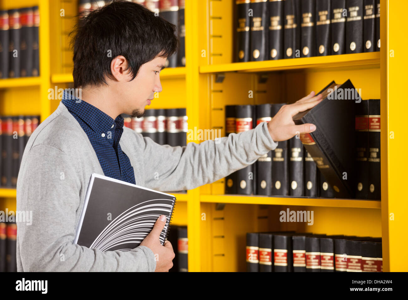 Asian student choosing book hi-res stock photography and images - Alamy