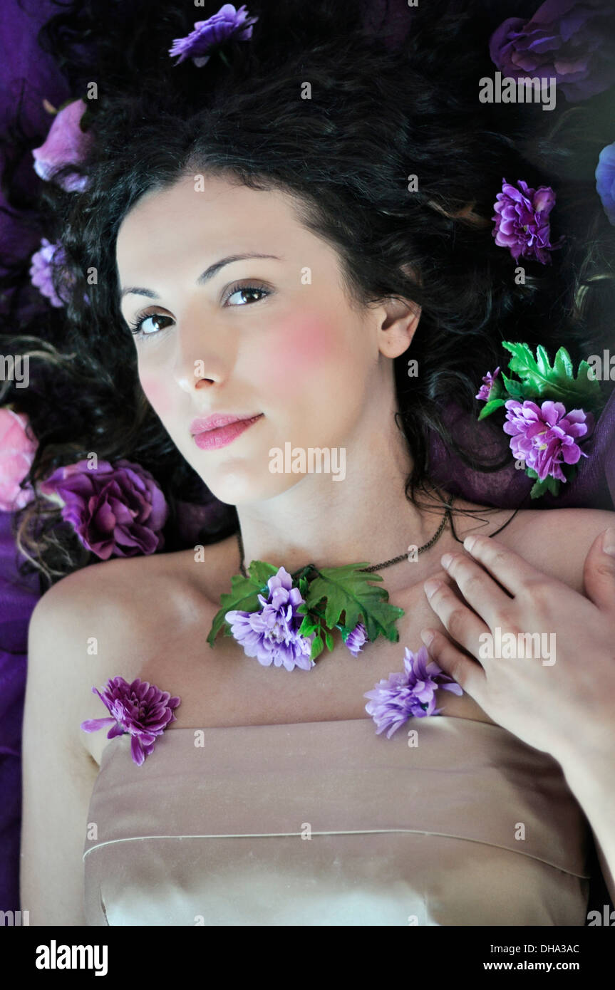 Portrait of a young beautiful woman lying on bed Stock Photo - Alamy