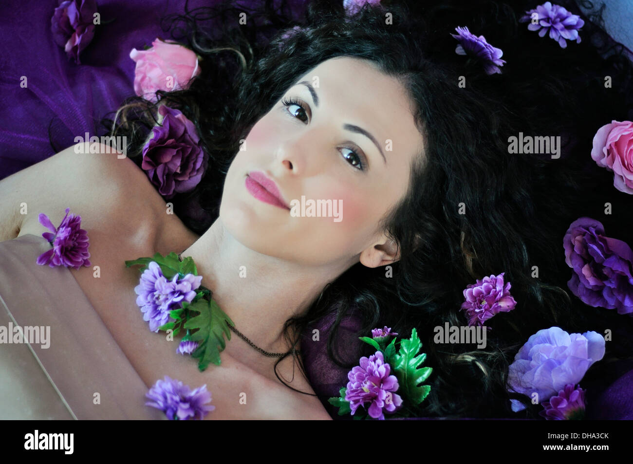 Portrait of a young beautiful woman lying on bed Stock Photo - Alamy