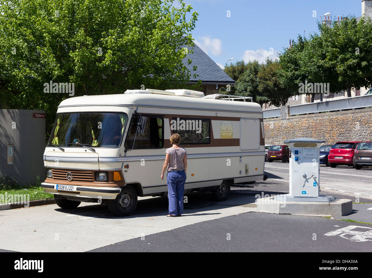 A vintage Mercedes motorhome at a service point (Camping Car Aire de Service) in the centre of a town in the Auvergne France Stock Photo