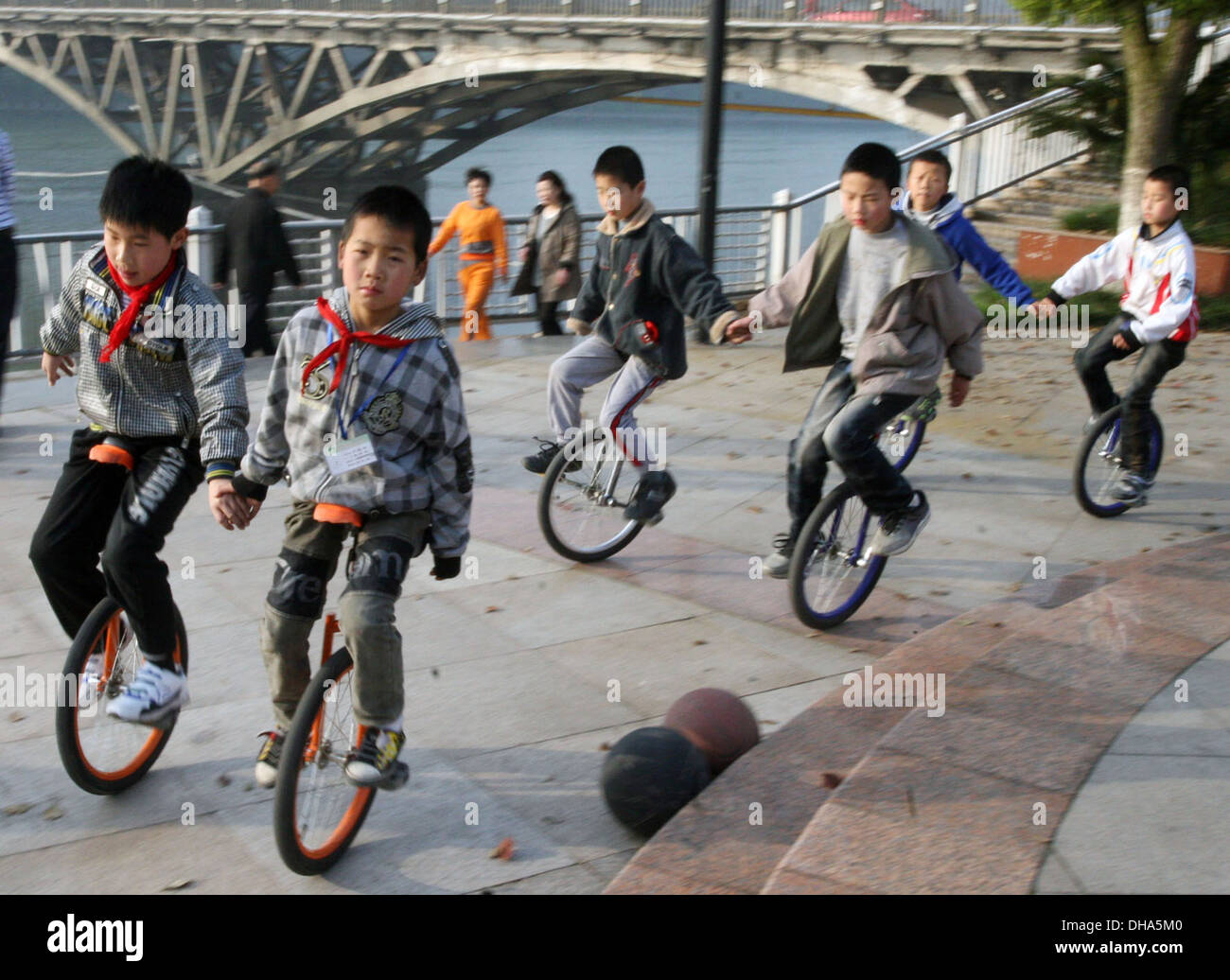 Kids on Unicycles A group of kids take a leisurely ride on their