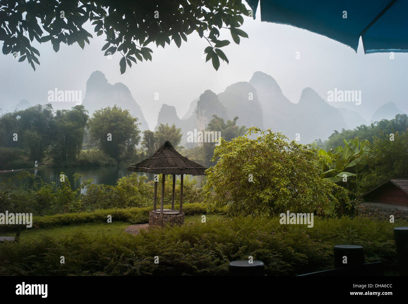 Lush Foliage And Mountain Peaks On A Rainy Day; Yangshuo, China Stock Photo