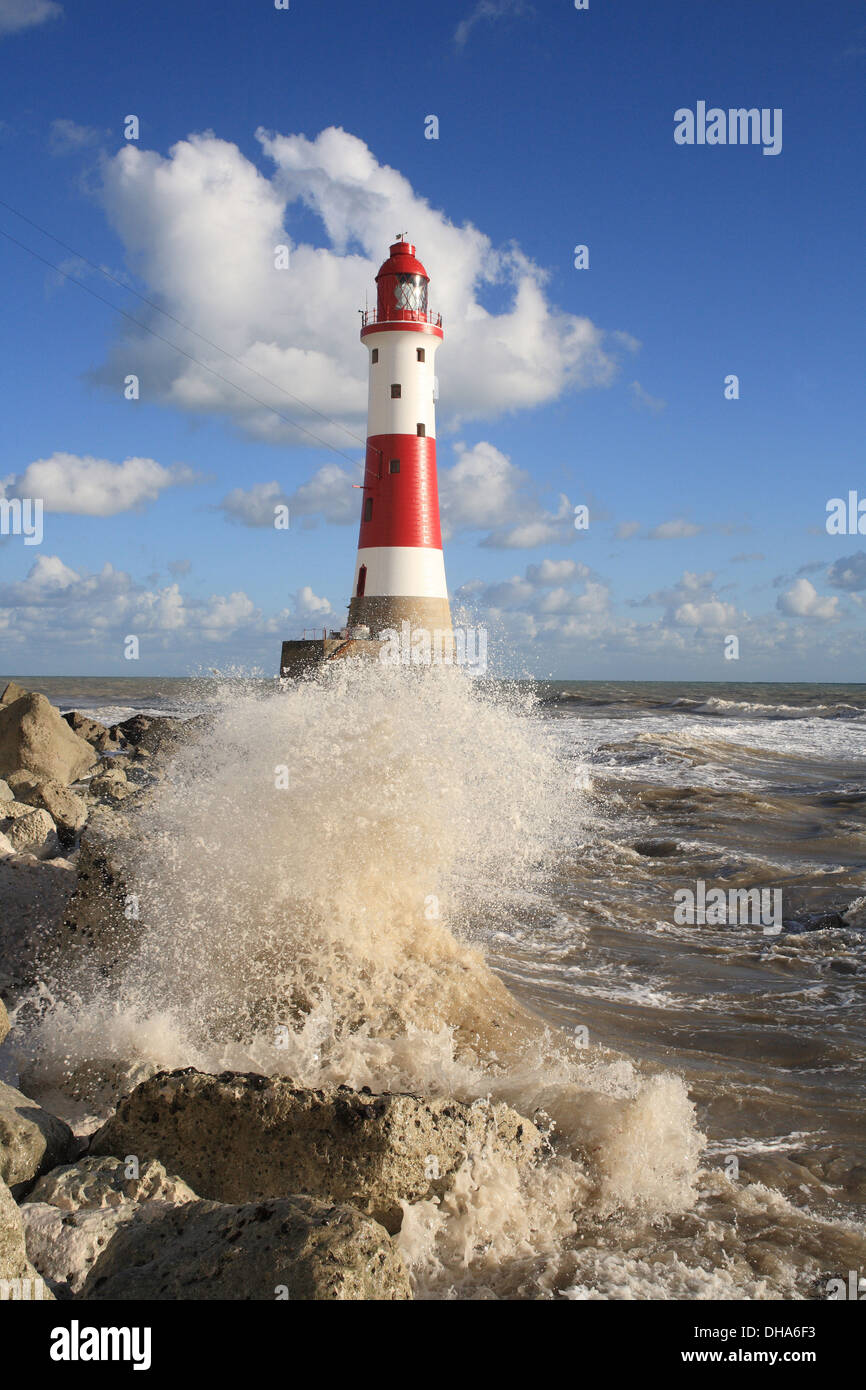 Beachy Head Lighthouse after recent repainting with crashing waves Stock Photo