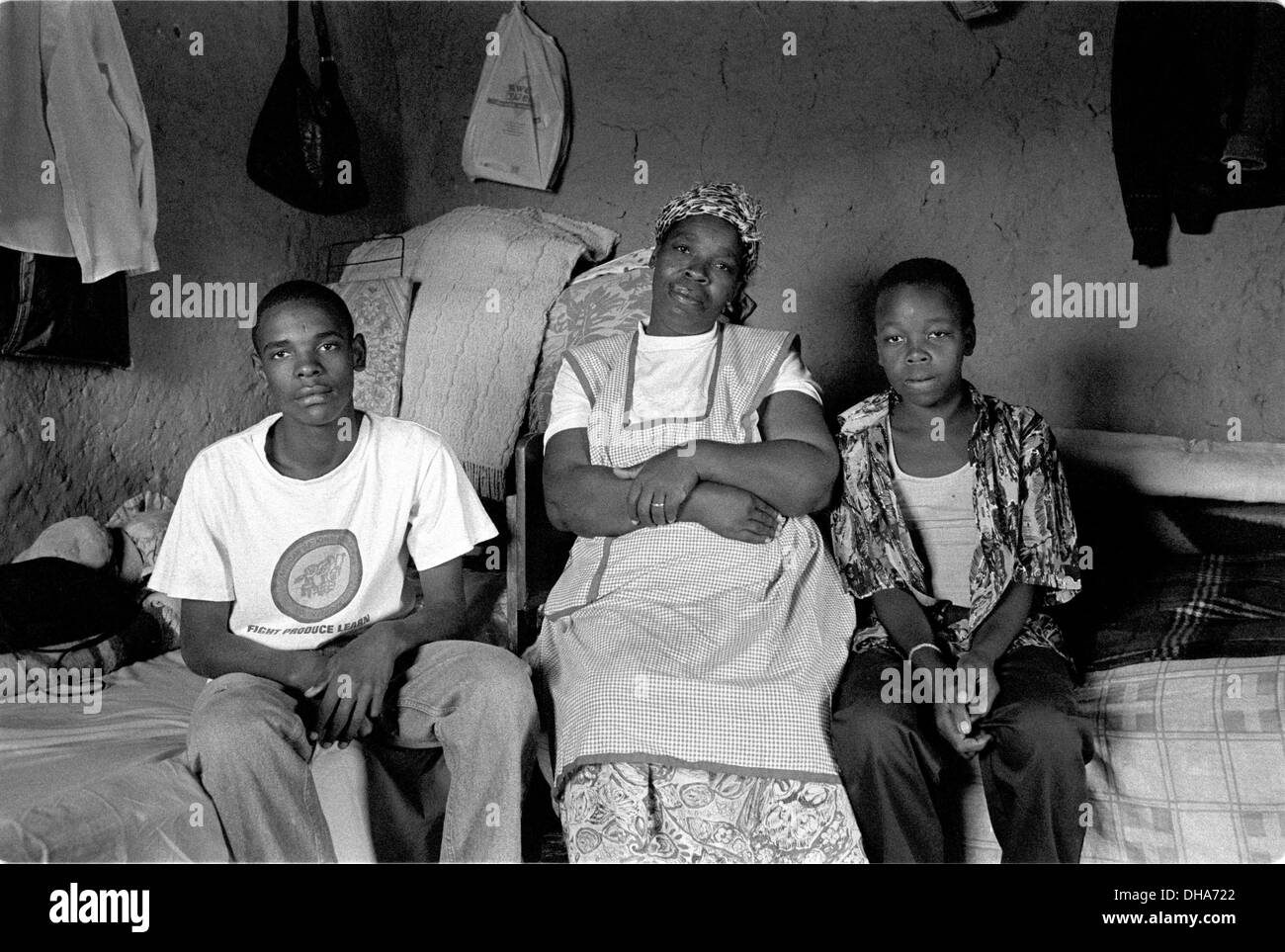 ipjr09090310Poverty and dignity. June 2004. Mother and sons in the origonal room of the family home.. Ms Mzila, is a single Stock Photo