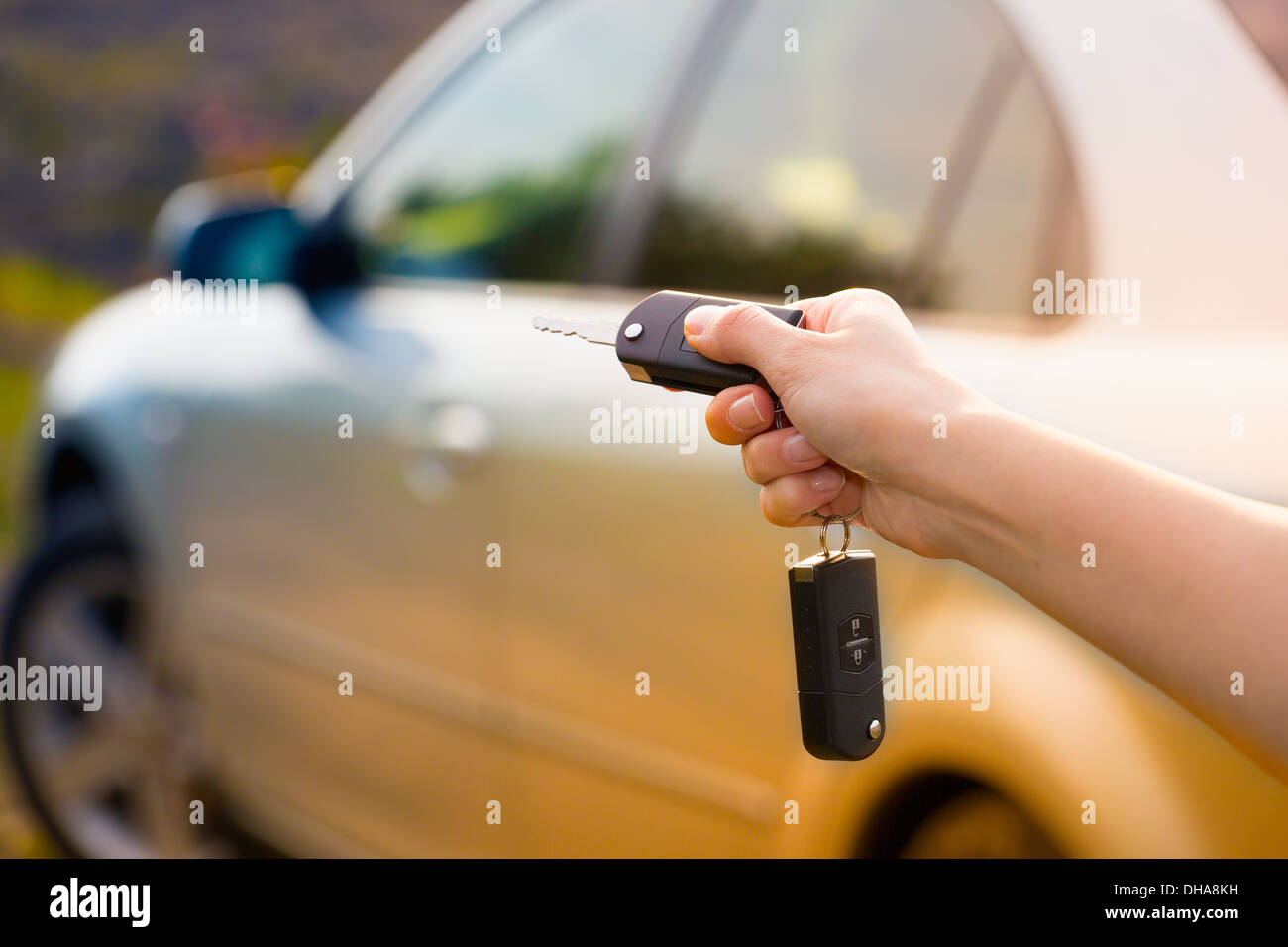 women's hand presses on the remote control car alarm systems Stock Photo