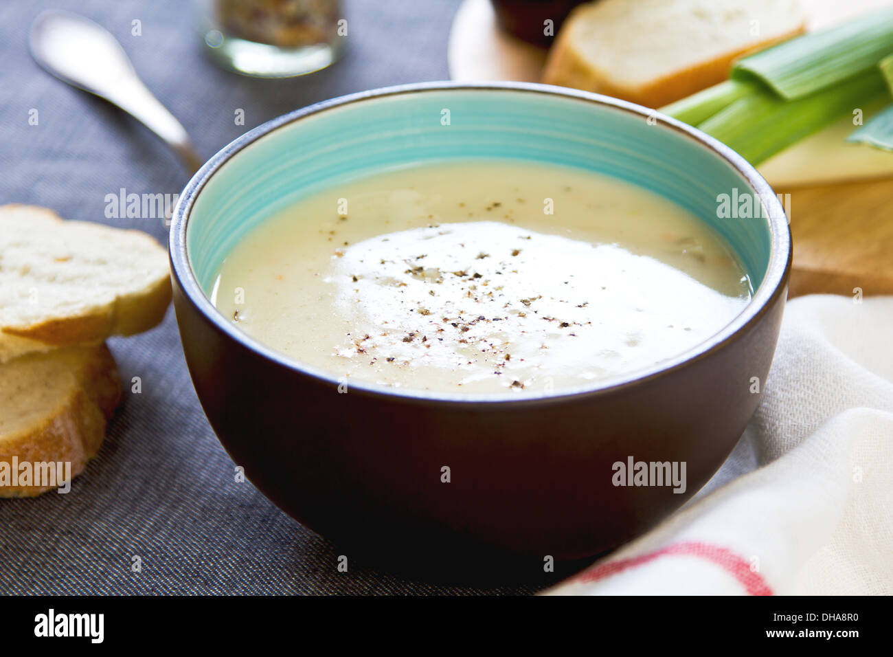 Leek and Potatoes soup by bread and fresh ingredients Stock Photo