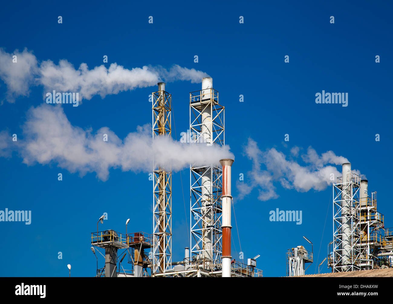 Smoking Refinery Stacks with Smoke in Macchiareddu in Southern Sardinia Stock Photo