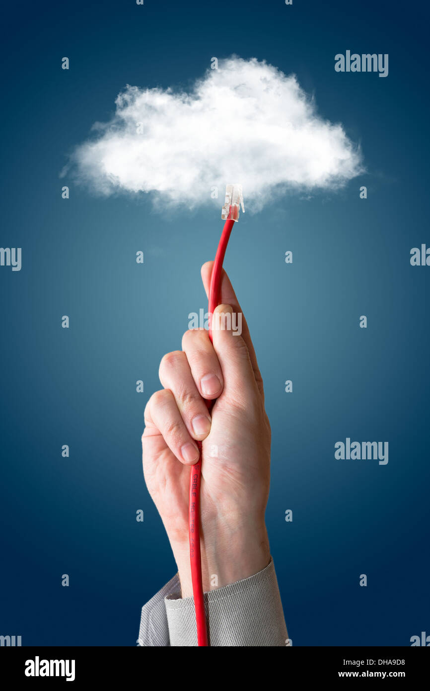 Cloud computing concept. Hand with ethernet cable connecting into cloud. Stock Photo