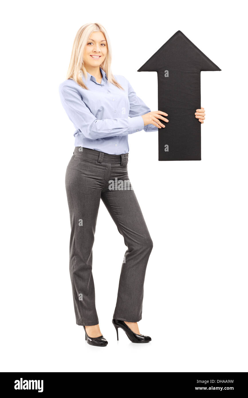 Full length portrait of a blond smiling woman holding a big black arrow ...