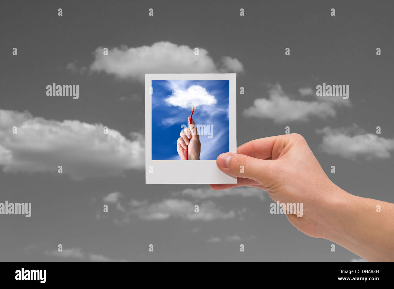 Holding instant cloud photo on a black sky background. Stock Photo