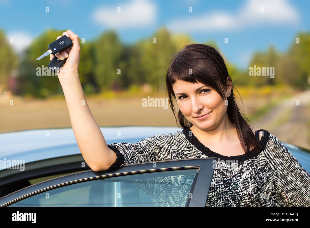 Beautiful young girl with car key in hand Stock Photo