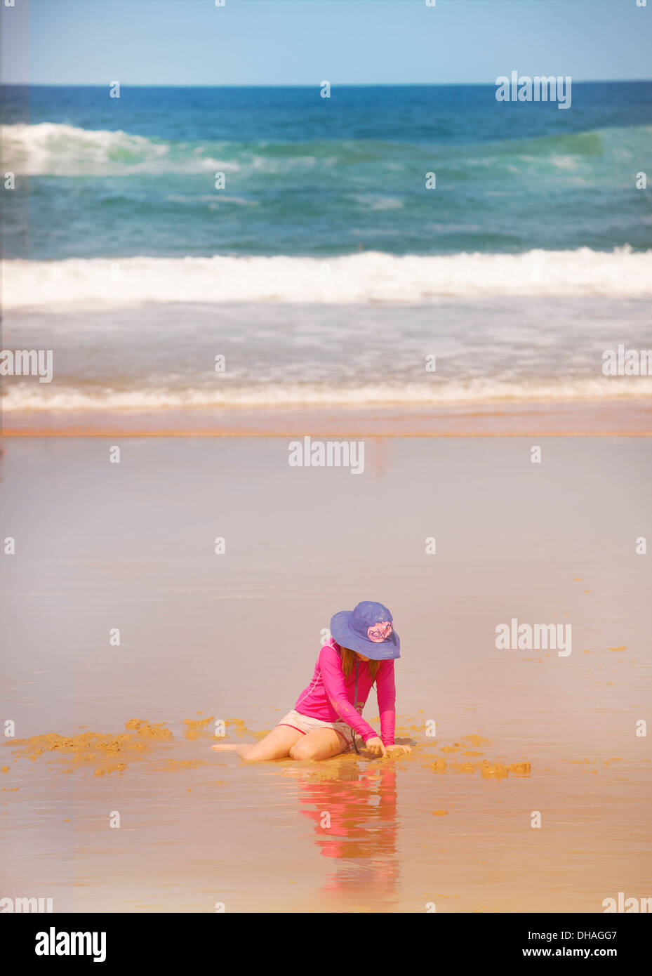 A young child age 5 playing on a beach in Queensland, Australia. Stock Photo