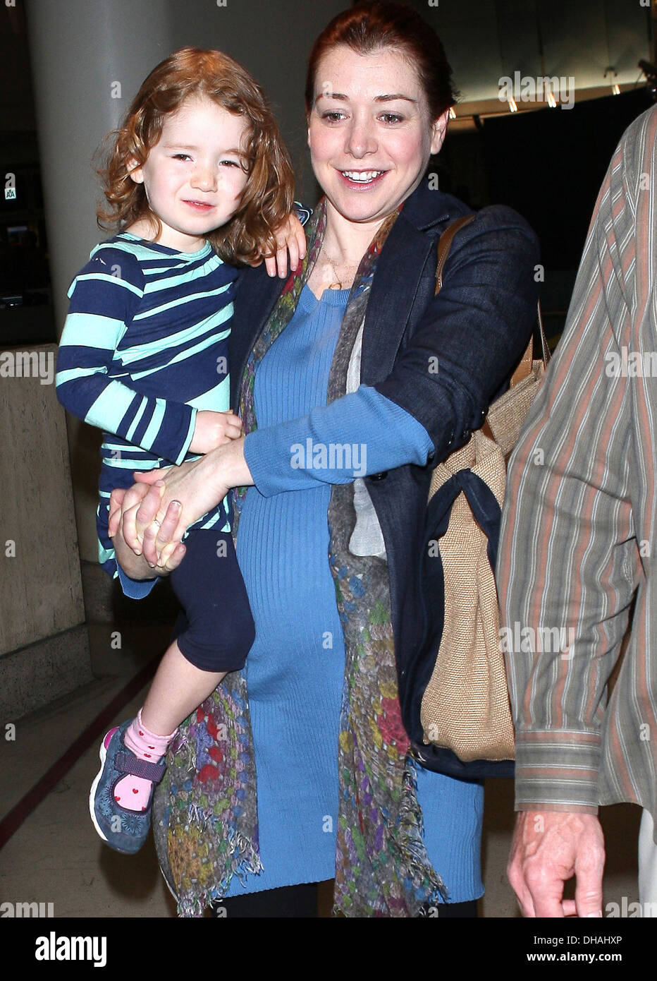 Pregnant Alyson Hannigan and her daughter Satyana Denisof arrive at LAX