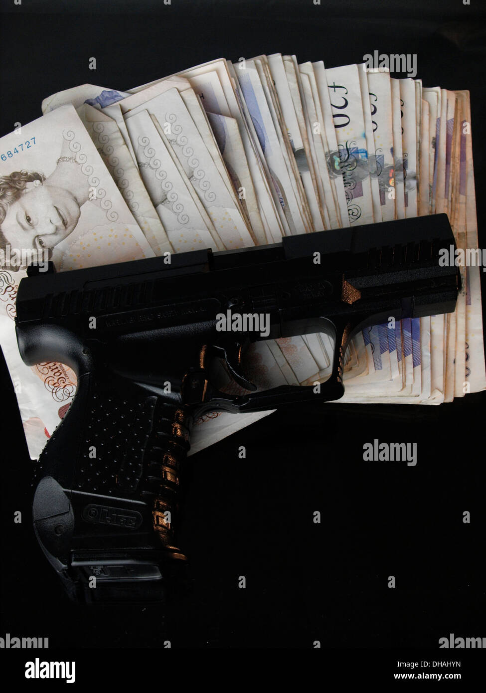 Gun and money, UK Stock Photo