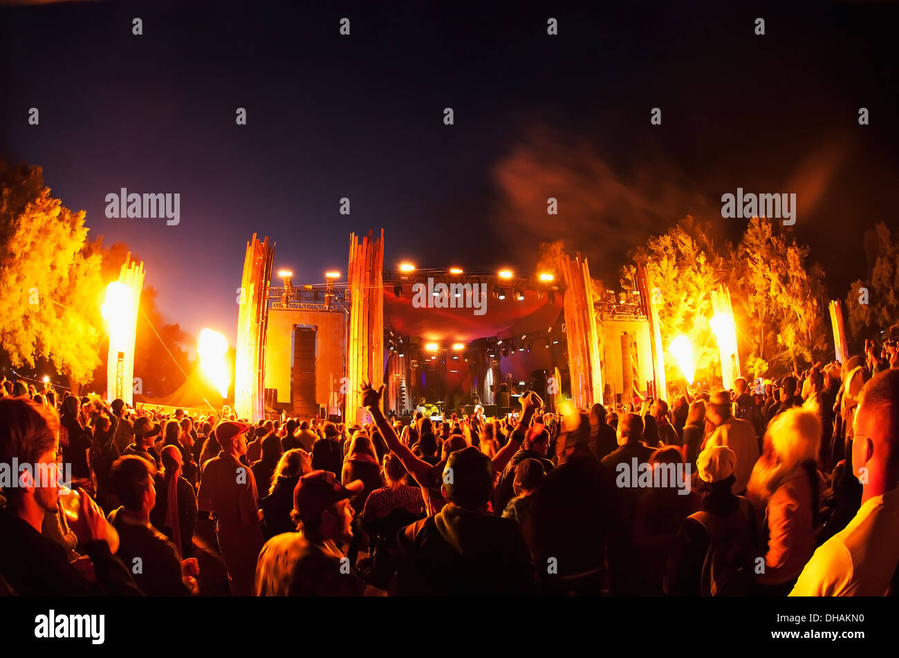 A Crowd During An Outdoor Music Event With Fire Being Shot Up From Both