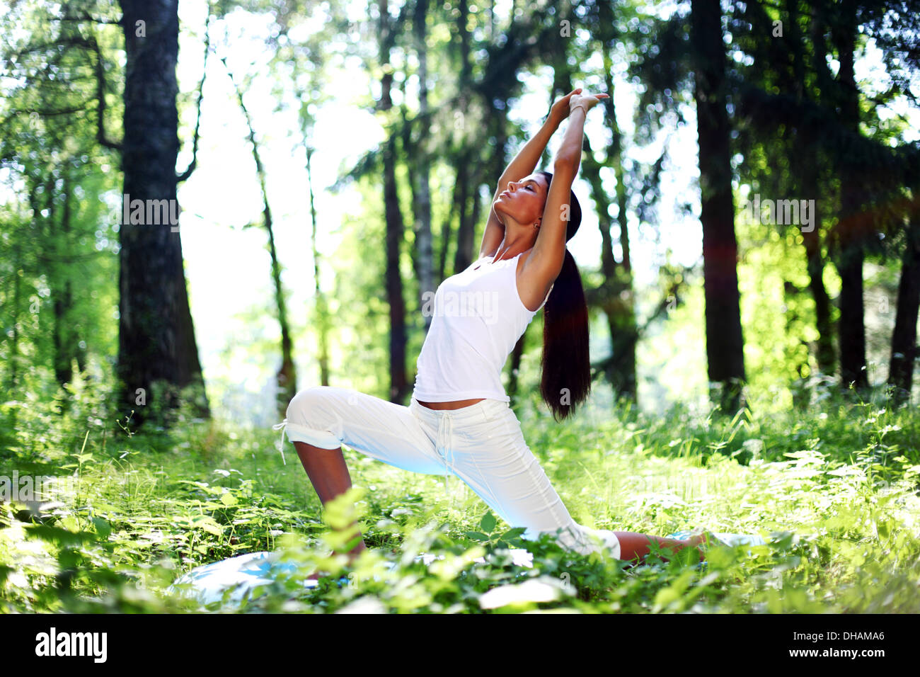 yoga woman on green park background Stock Photo Alamy