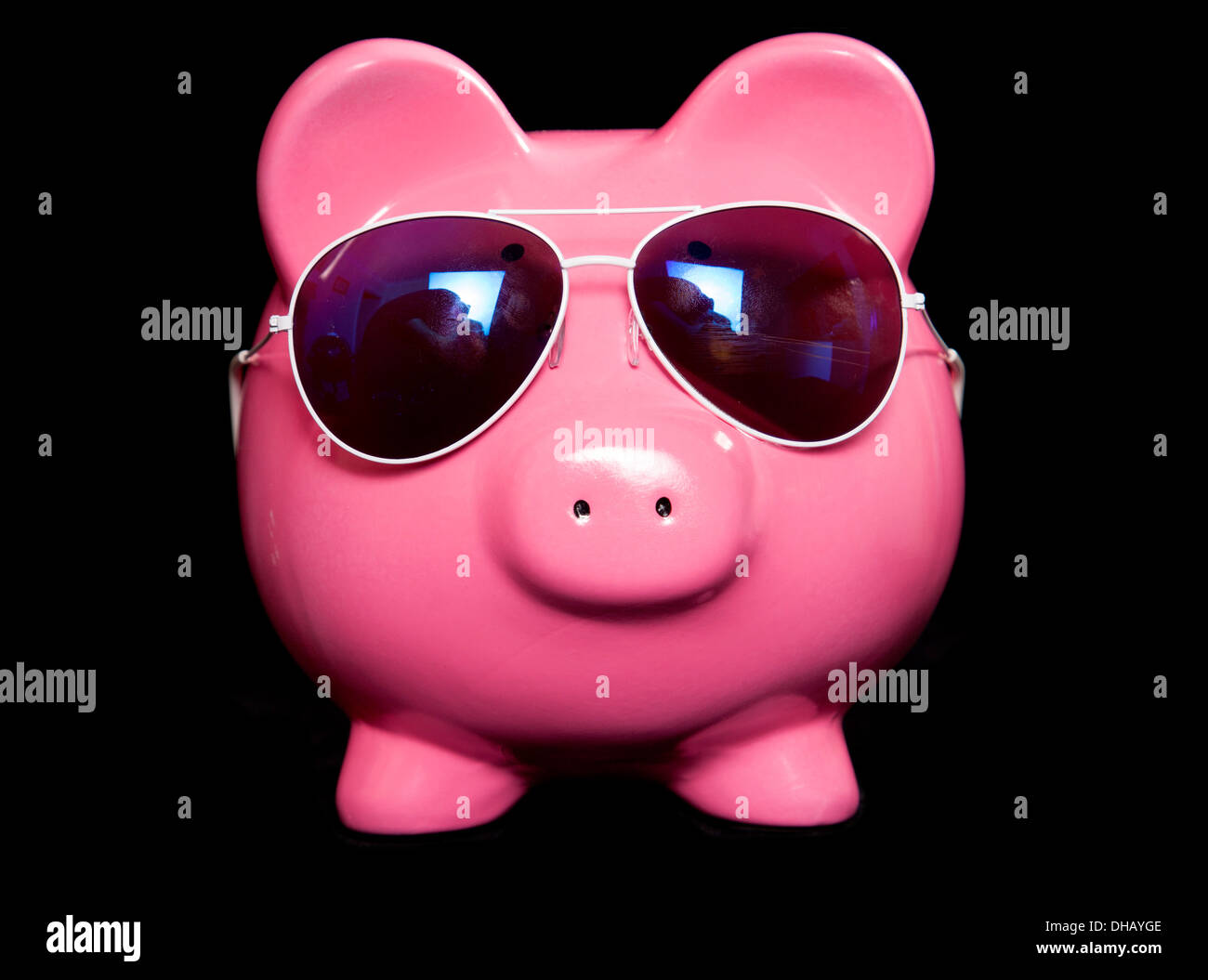 Piggy bank wearing retro sun glasses studio cutout Stock Photo