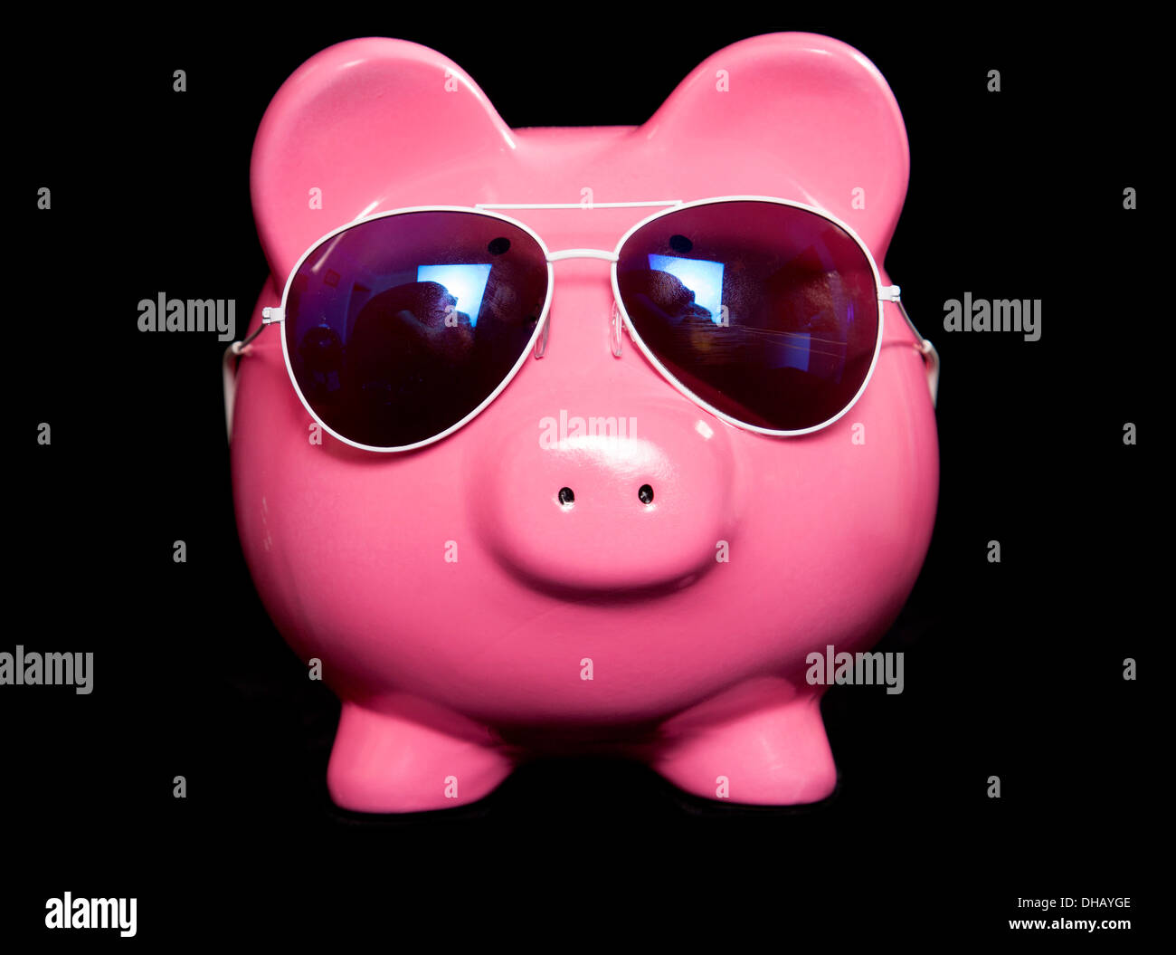 Piggy bank wearing retro sun glasses studio cutout Stock Photo - Alamy