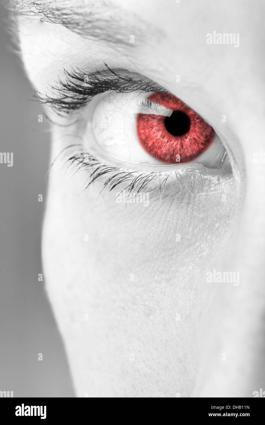 Striking closeup view of a woman's eye with a red iris Stock Photo