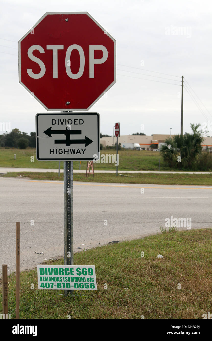 Ironic sign on a highway intersection, Stop divided highway with a $99 divorce services advertised November 2013 Stock Photo