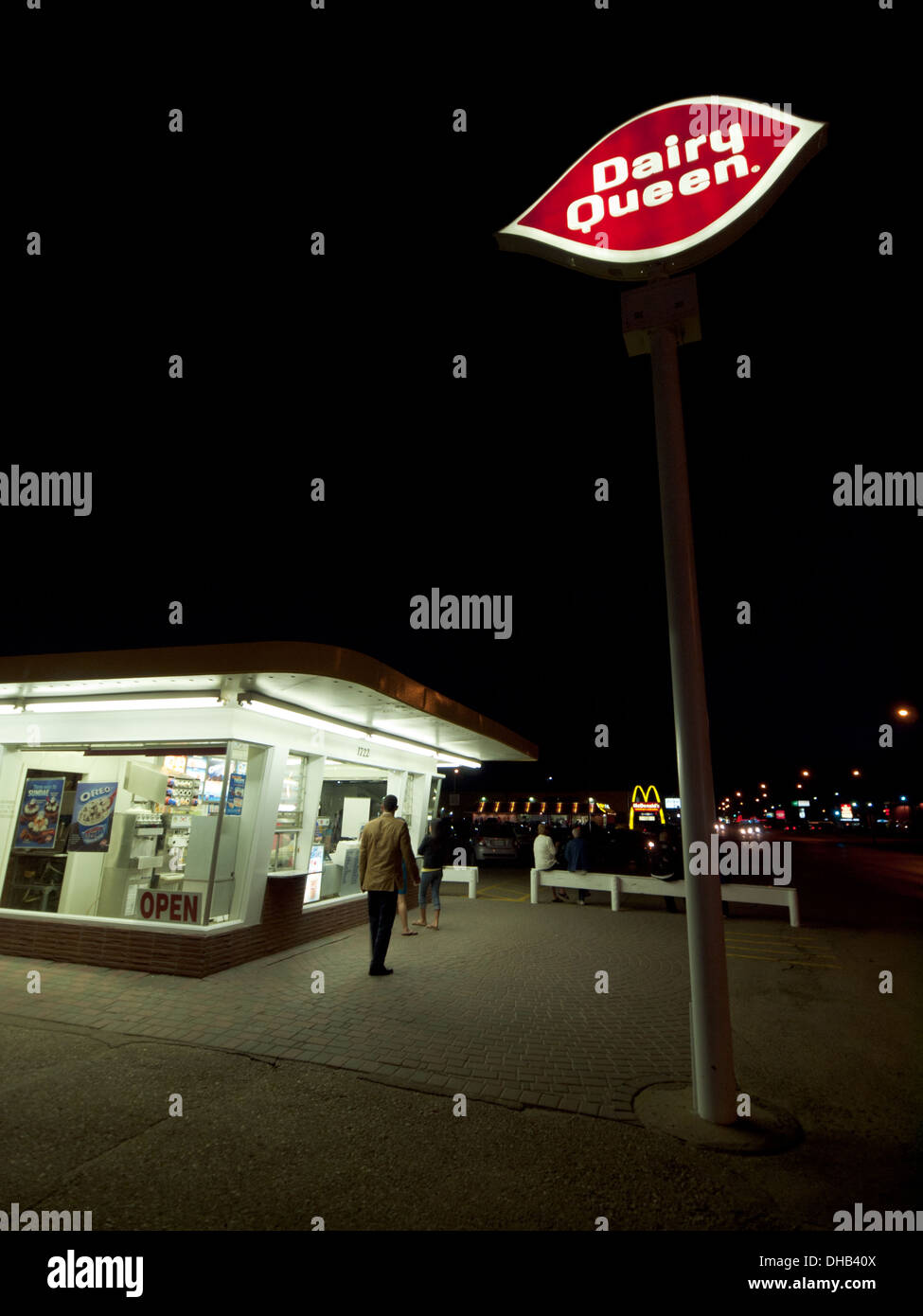 A nighttime view of a crowd waiting in line for ice cream at the Dairy