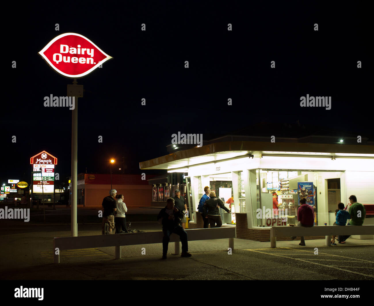 A nighttime view of a crowd waiting in line for ice cream at the Dairy