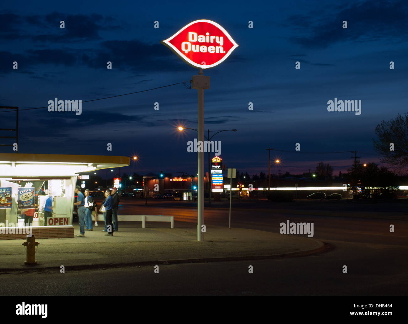 A nighttime view of a crowd waiting in line for ice cream at the Dairy Queen on 1722 - 8th Street in Saskatoon, Canada. Stock Photo