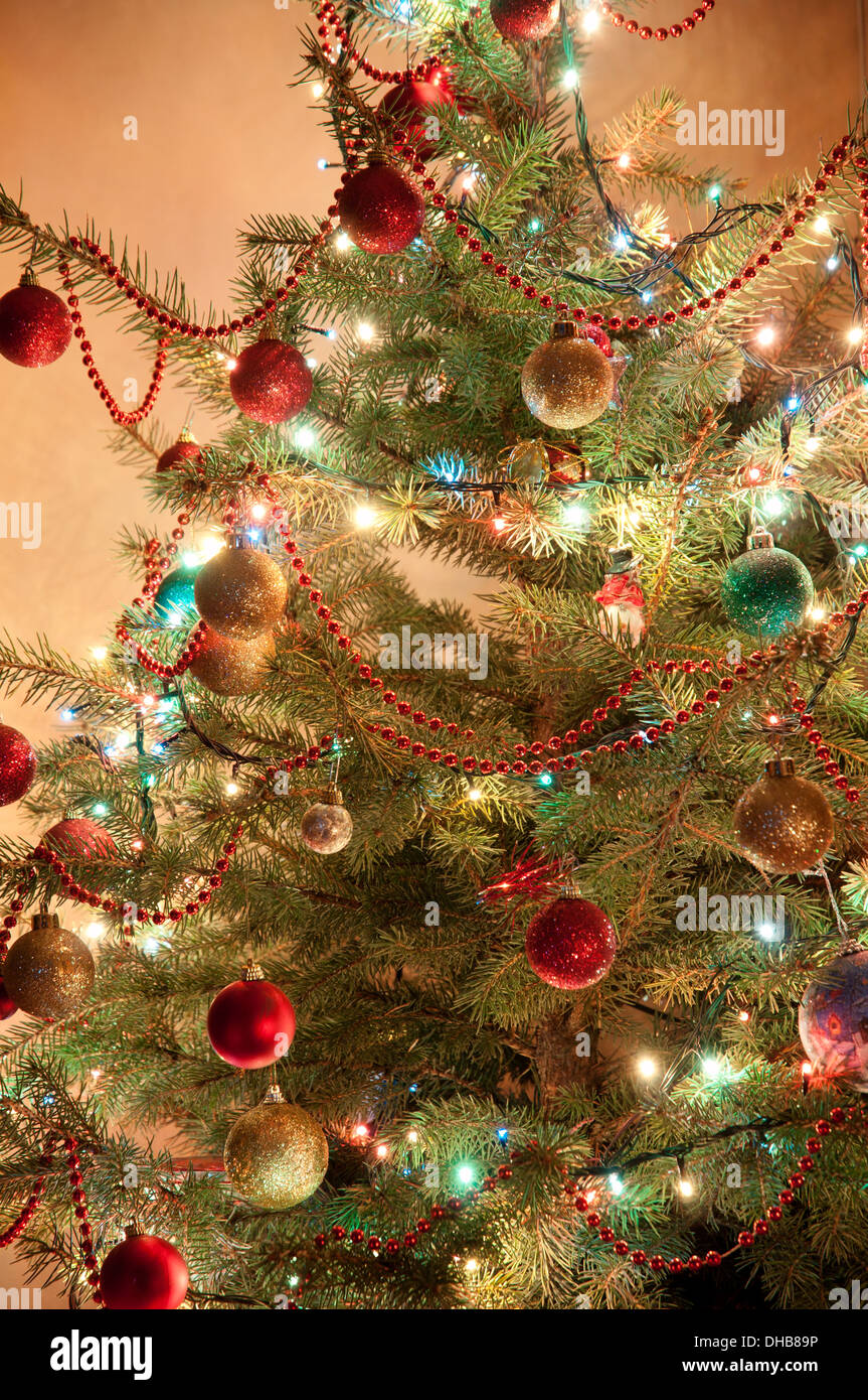 Illuminated Christmas tree at night with presents Stock Photo