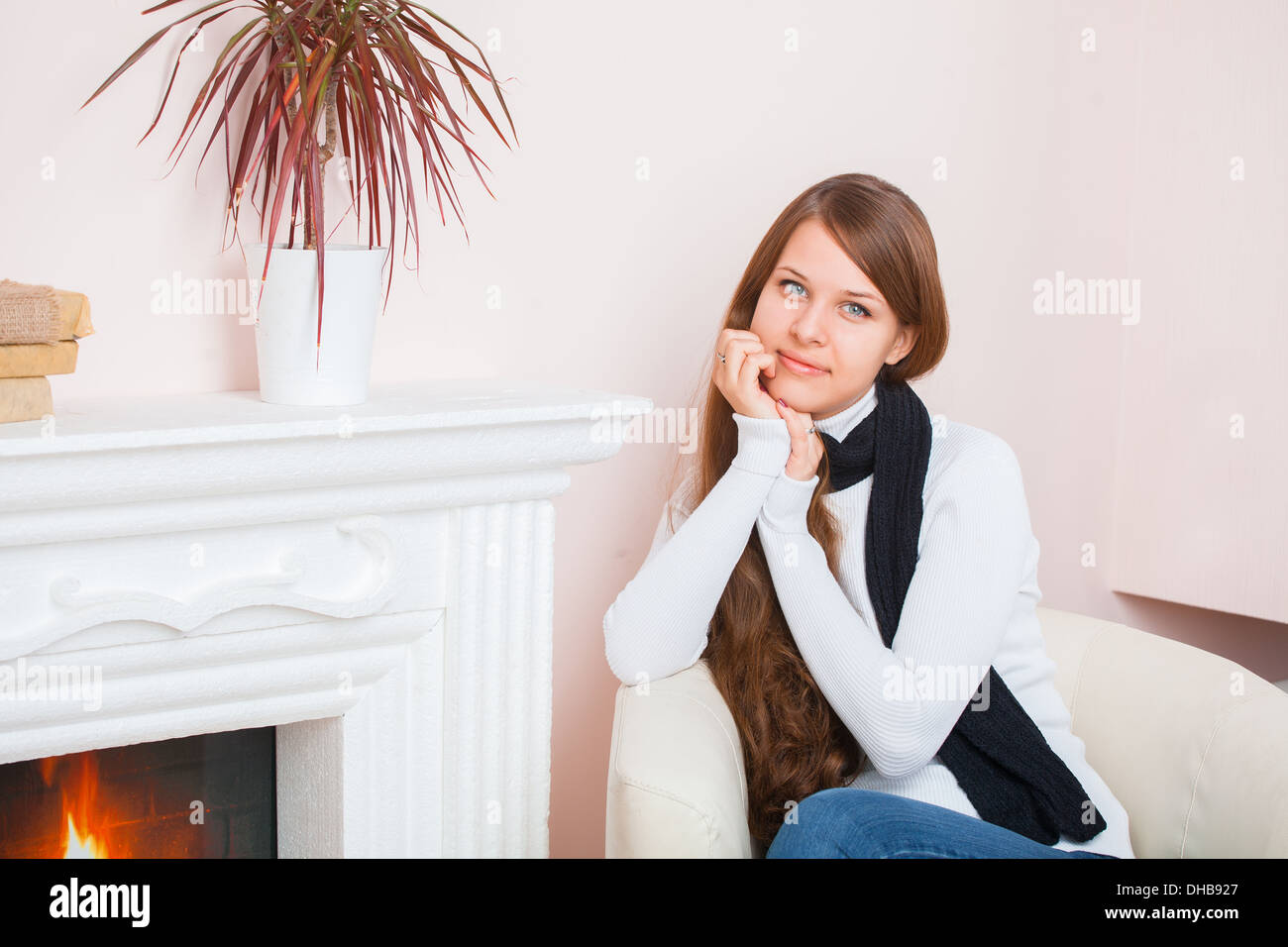 Girl sitting by the fireplace Stock Photo - Alamy