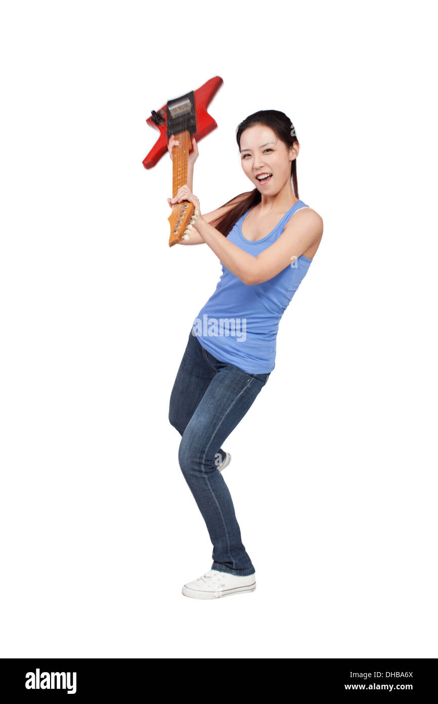 Smiling girl holding an electric guitar Stock Photo