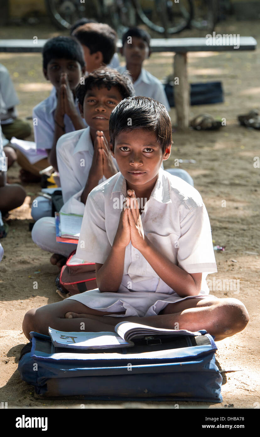 Rural Indian village high school boys doing morning prayers in an outside class. Andhra Pradesh, India Stock Photo