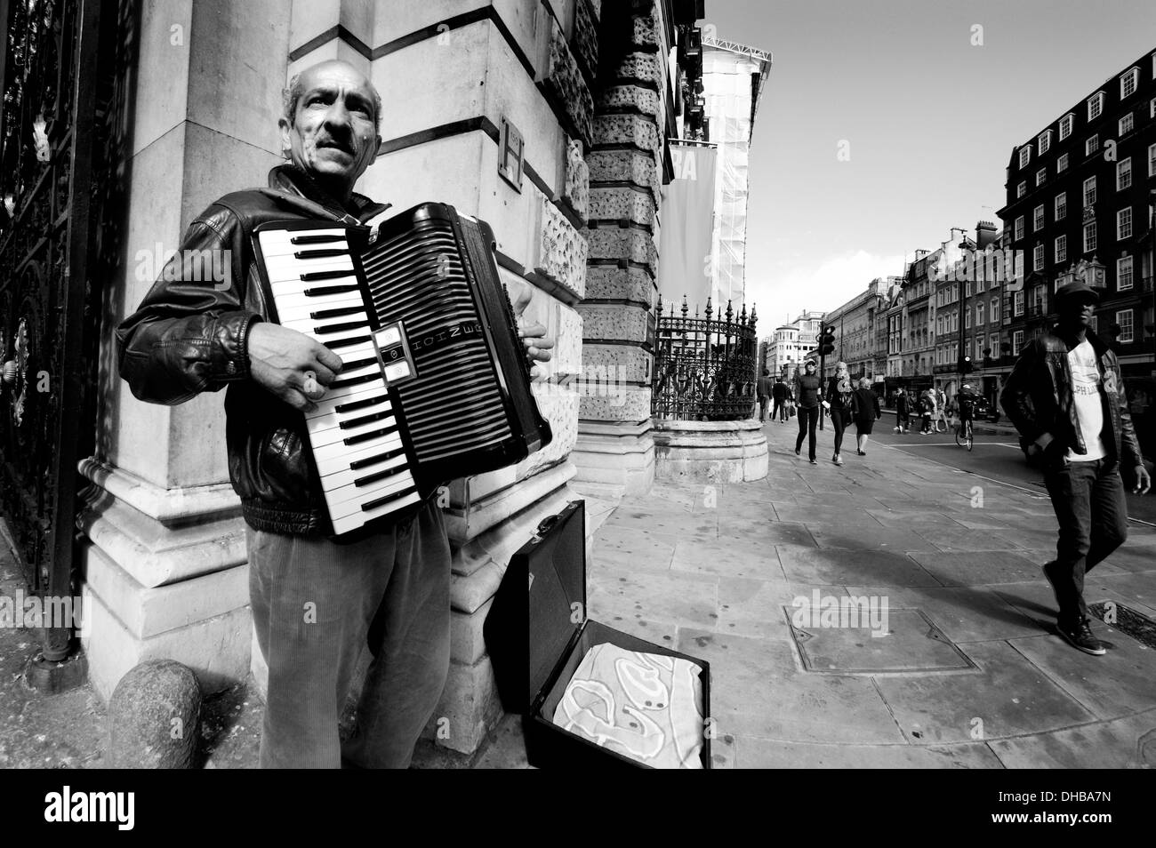 London, England, UK. Busker playing the accordion in Piccadilly, by the Royal Academy. Stock Photo