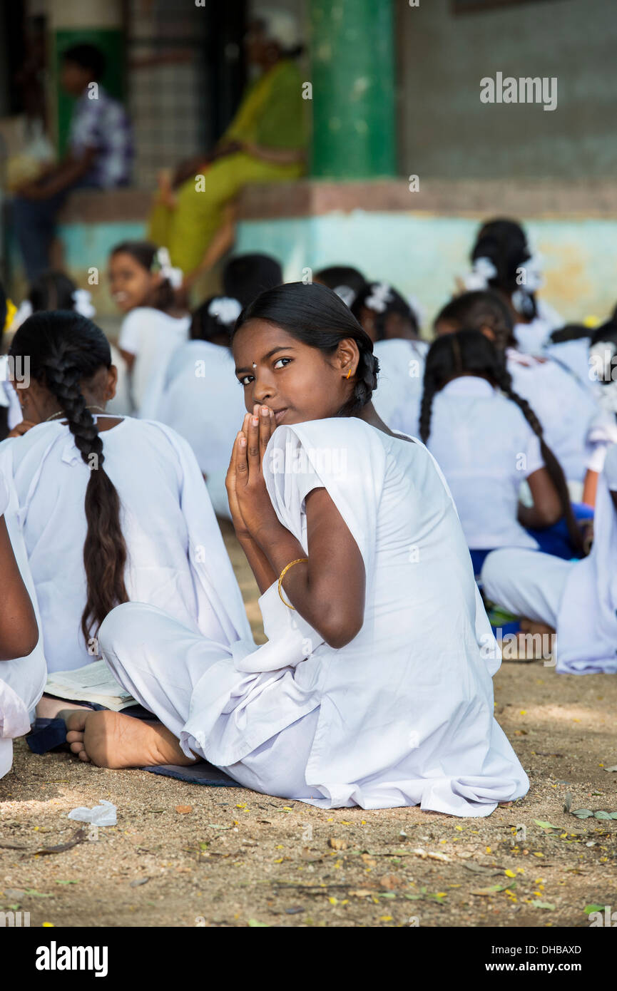Rural Indian village high school girl doing morning prayers in an outside class. Andhra Pradesh, India Stock Photo