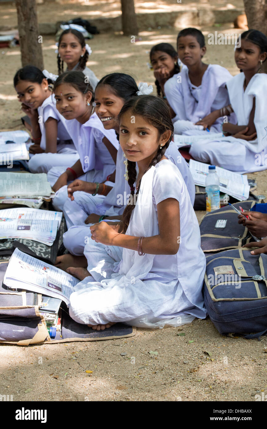 Rural Indian village high school girls writing in books in an outside class. Andhra Pradesh, India Stock Photo