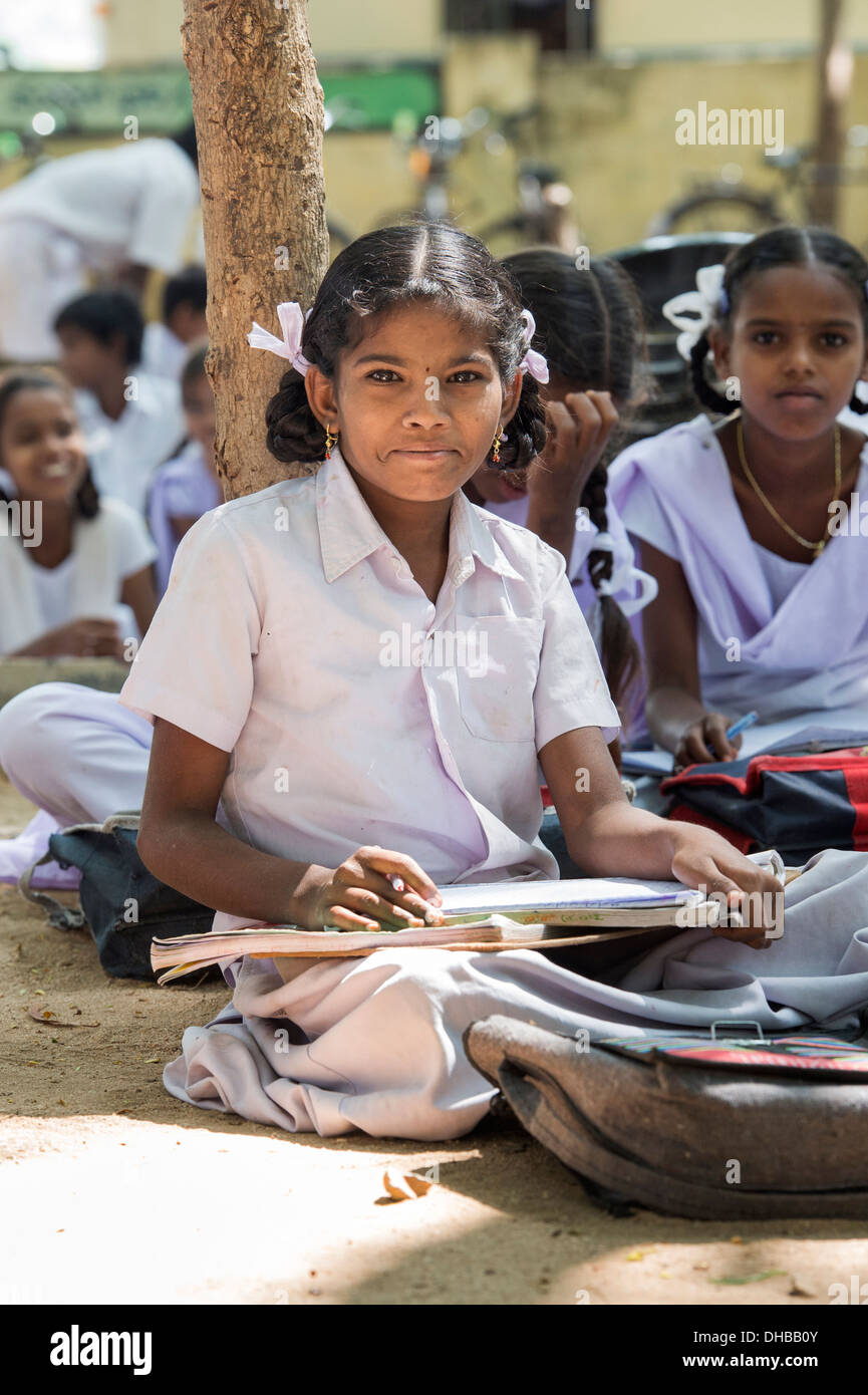 Rural Indian village high school girls writing in books in an outside class. Andhra Pradesh, India Stock Photo