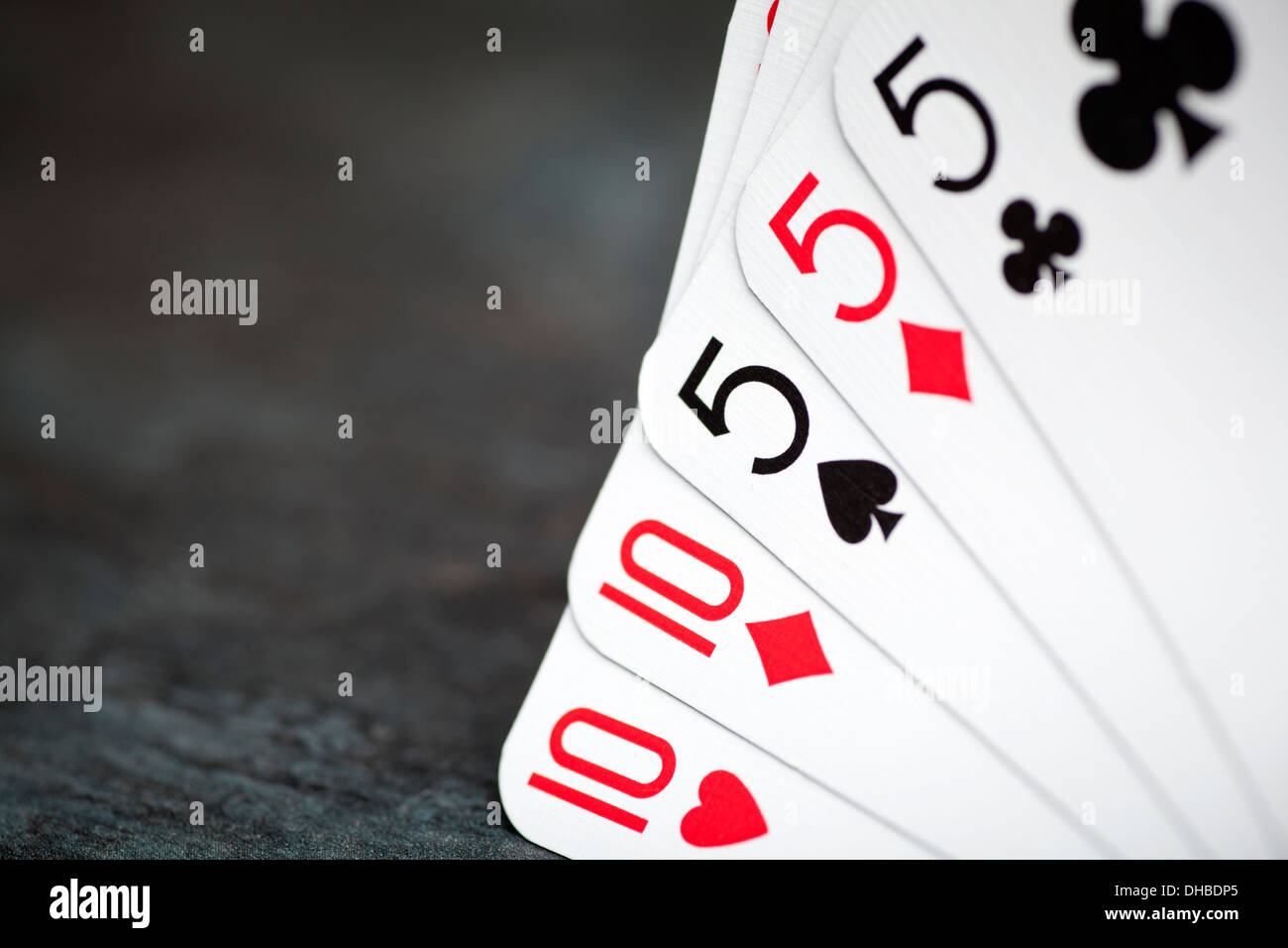 Full House poker hand with 10's and 5's Stock Photo