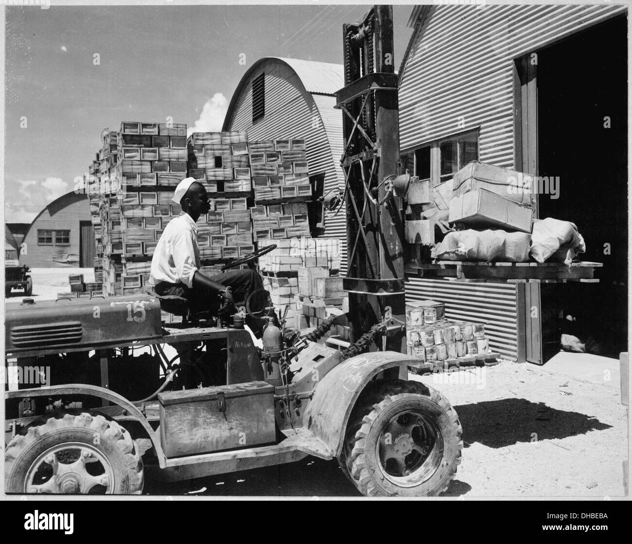 M. D. Shore, S1-c, operating a forklift truck at the Navy supply depot at Guam, Marianas. , 06-08-1945 520685 Stock Photo