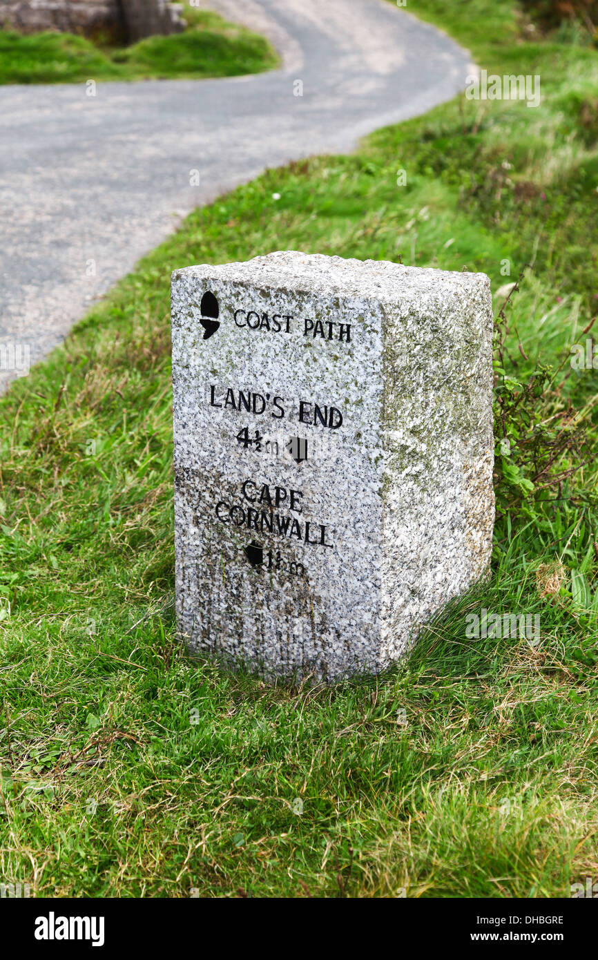 A sign post or stone by the road which is the south west Coastal path near Land's End and Cape Cornwall, Cornwall England UK Stock Photo