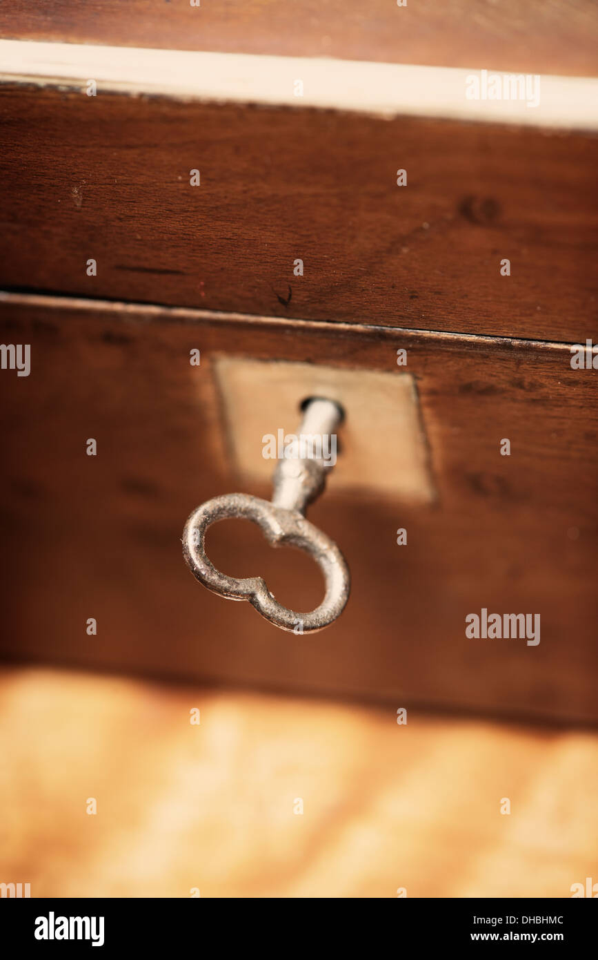 Closeup of closed vintage wooden chest and key Stock Photo