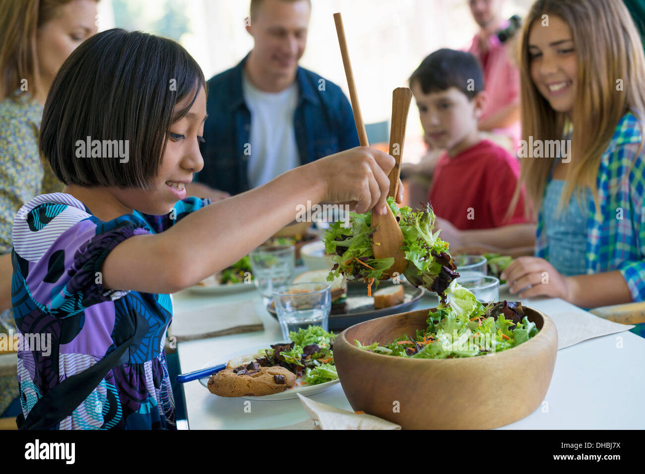 A family party around a table in a cafe. Adults and children. Stock Photo