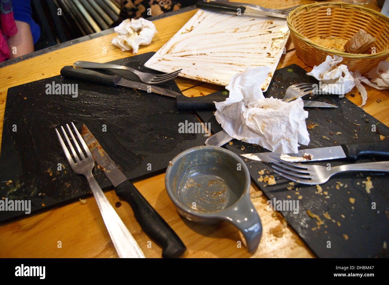 Cutlery and crockery left over after a lunch meal at Entrepotes restaurant, Toulouse,  Haute-Garonne, Midi- Pyréneés, Occitanie, France Stock Photo