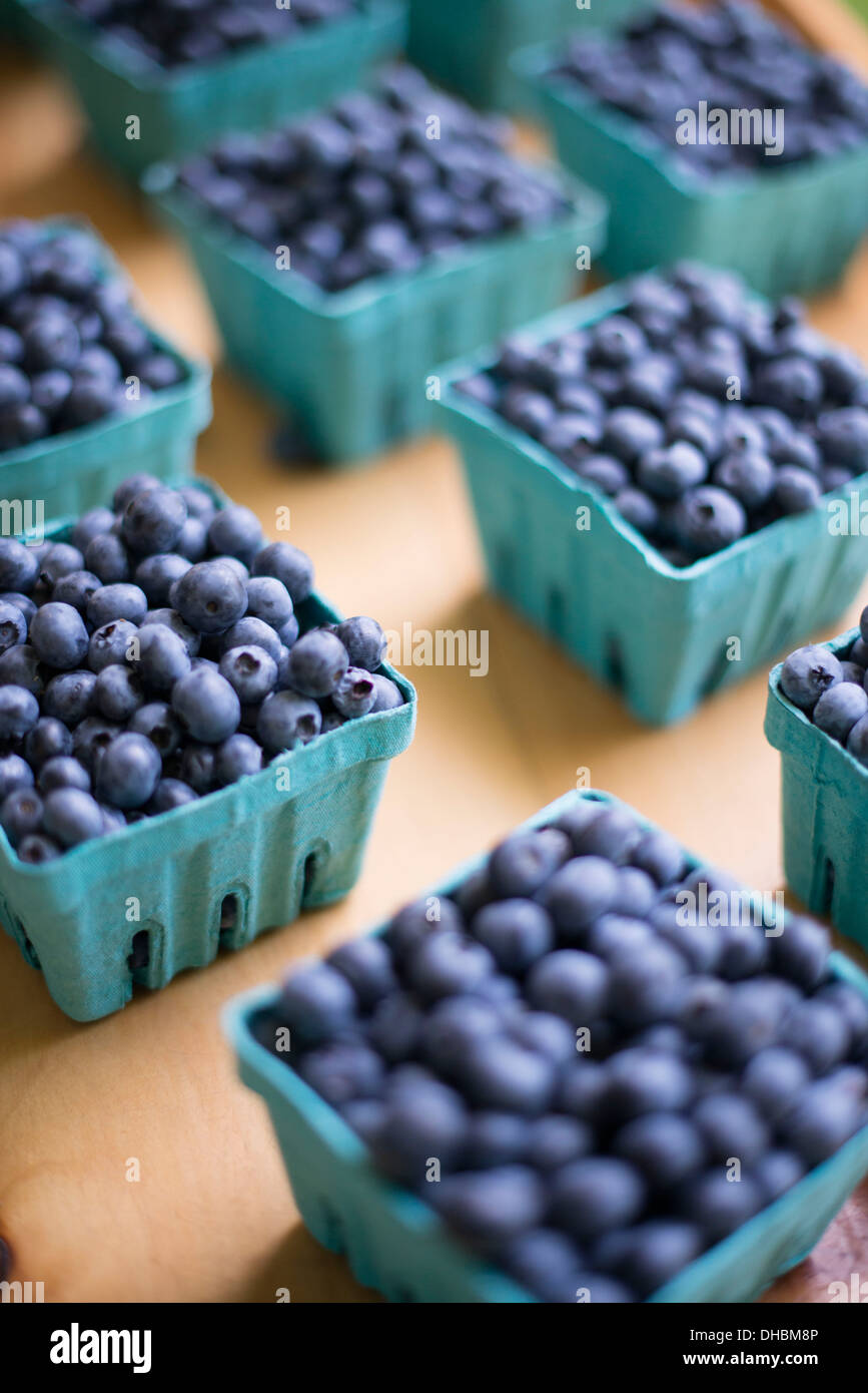 Organic fruit displayed on a farm stand. Blueberries in punnets. Stock Photo
