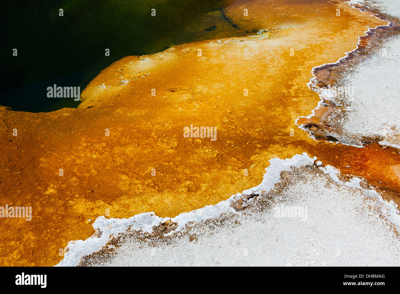 Detail of colourful water mineral deposits and rock formations from Midway Geyser, in Yellowstone National Park. Stock Photo