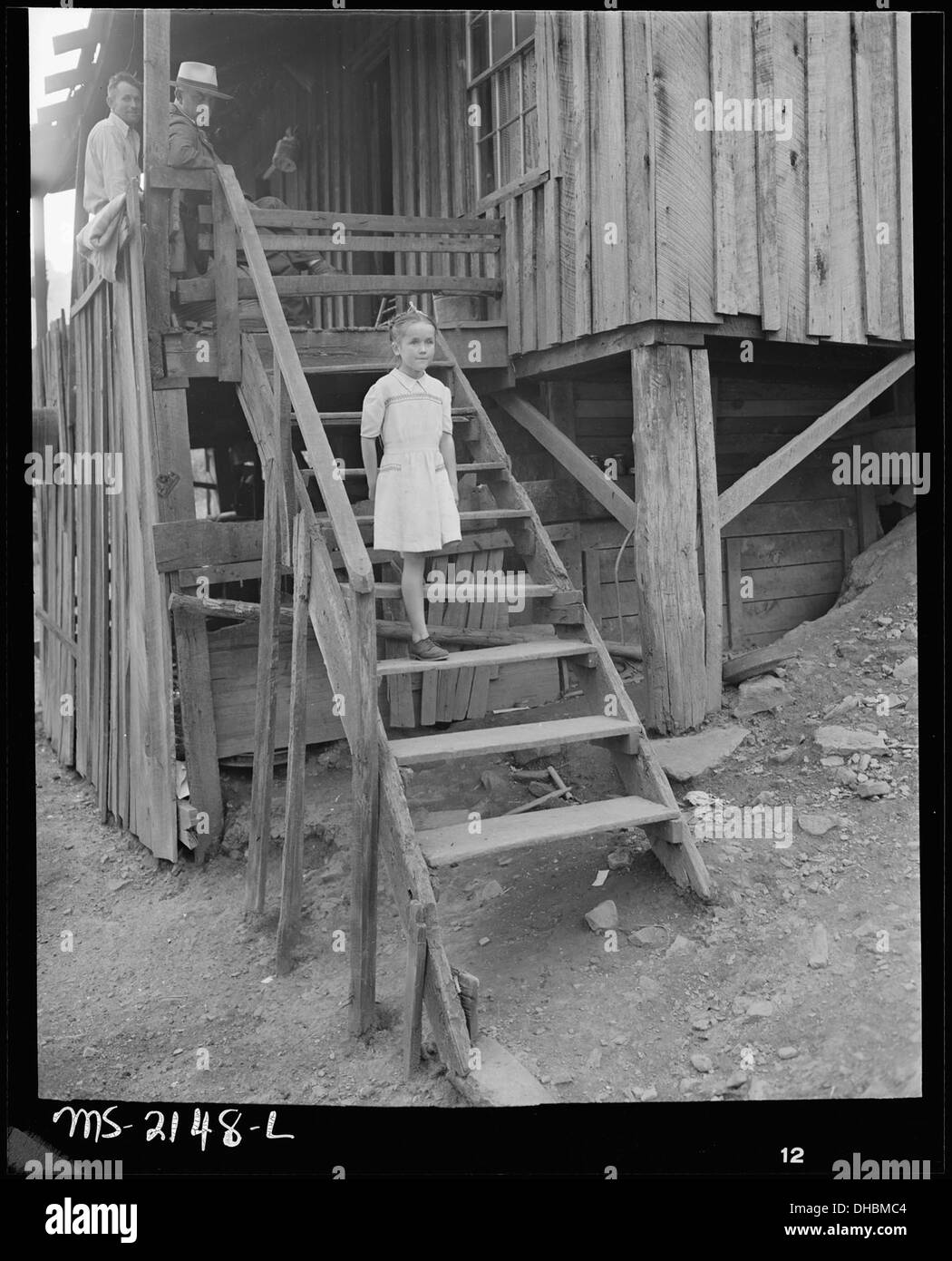 Daughter of Charlie Davis walking down the steps. Coleman Fuel Company, Red Bird Mine, Field, Bell County, Kentucky. 541138 Stock Photo