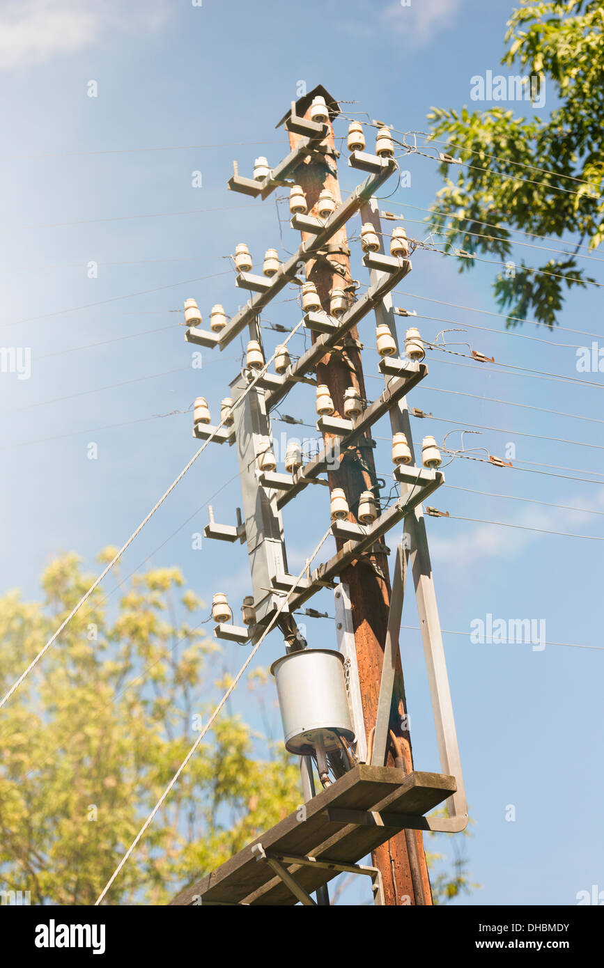 Old fashioned telephone pole and blue sky, Sweden Stock Photo