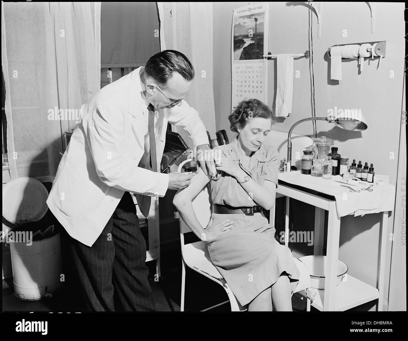 Doctor gives wife of miner an innoculation in dispensary. Inland Steel Company, Wheelwright 5E1 & 2 Mines... 541466 Stock Photo