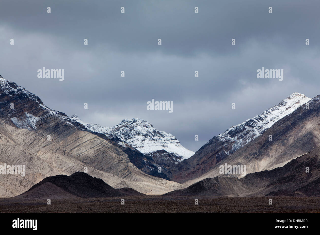 Snow covered mountains and ominous sky, Panamint Mountains, Death Valley NP Stock Photo