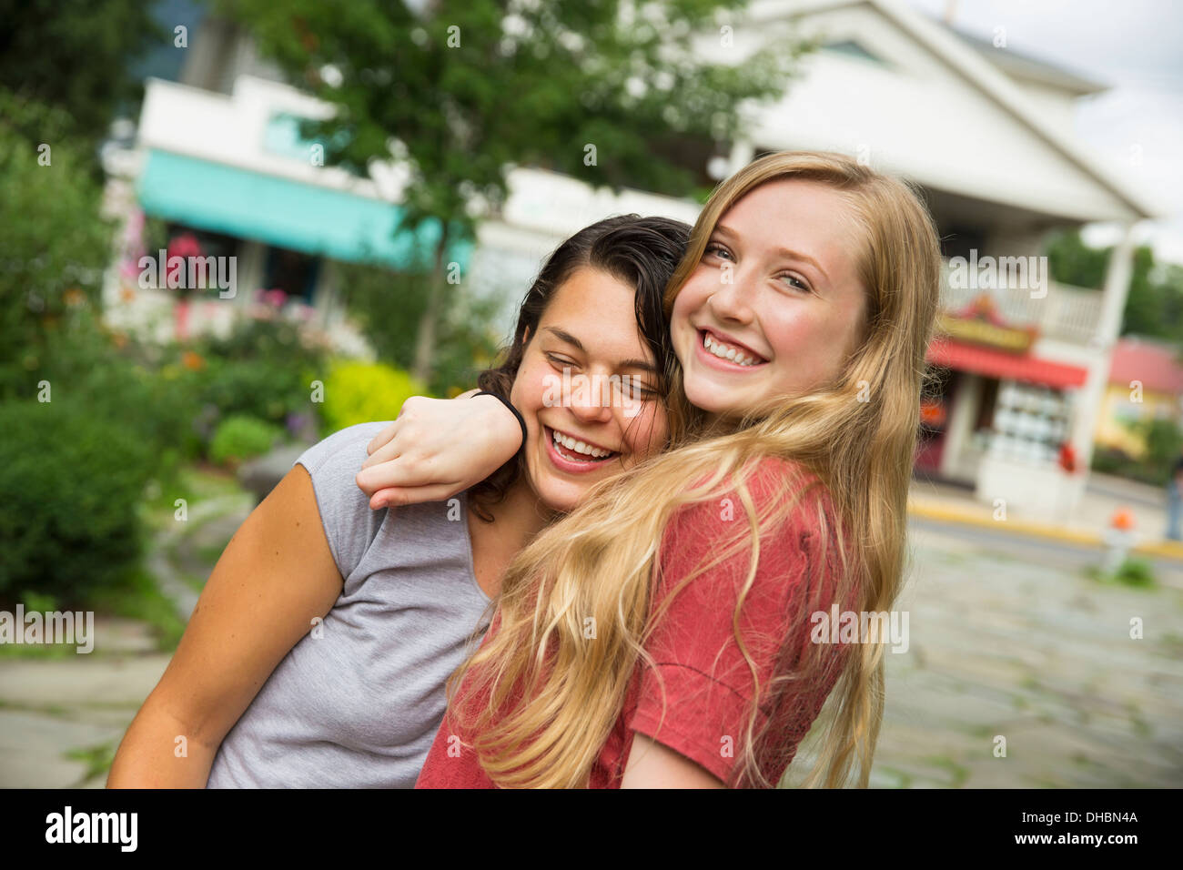 Two girls hugging and laughing. Stock Photo