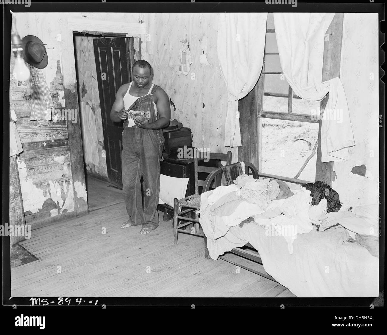 Eddie Cain, miner, looking over his bills in his home in company housing project. Adams, Rowe & Norman Inc., Porter... 540596 Stock Photo