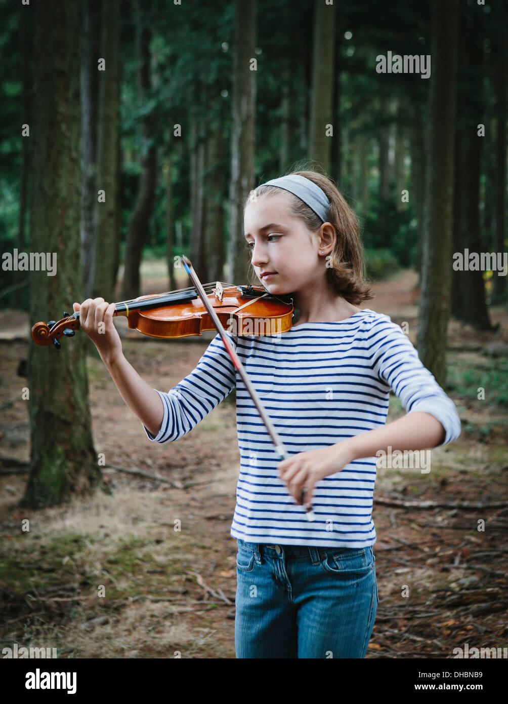 A ten year old girl playing the violin in Discovery Park, Seattle. Stock Photo
